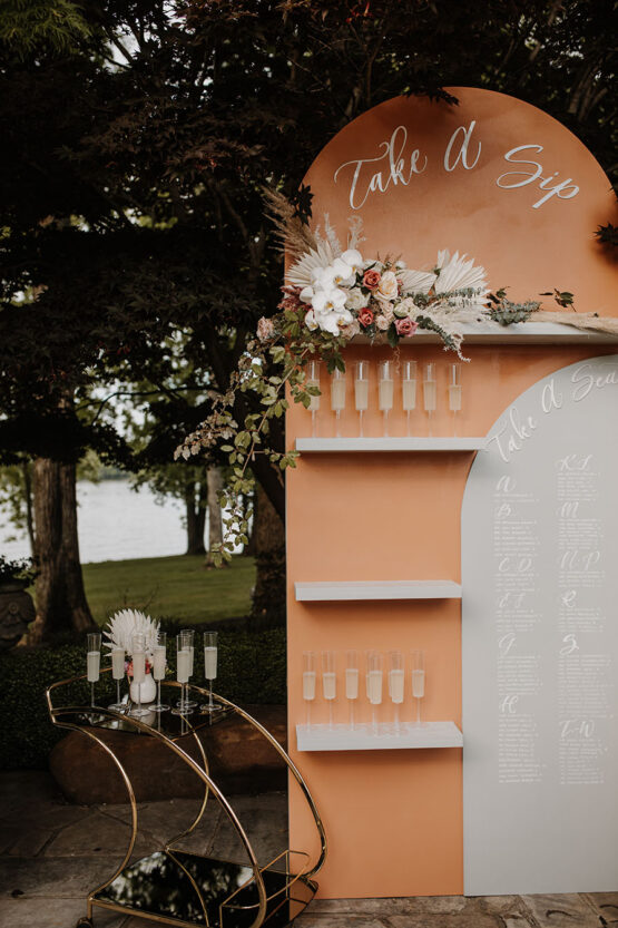 boho inspired seating chart display with champagne flutes