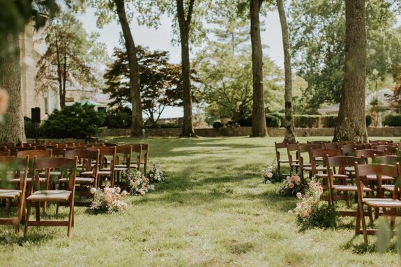 Wedding ceremony chairs on Lakeside Lawn with the mansion in the background